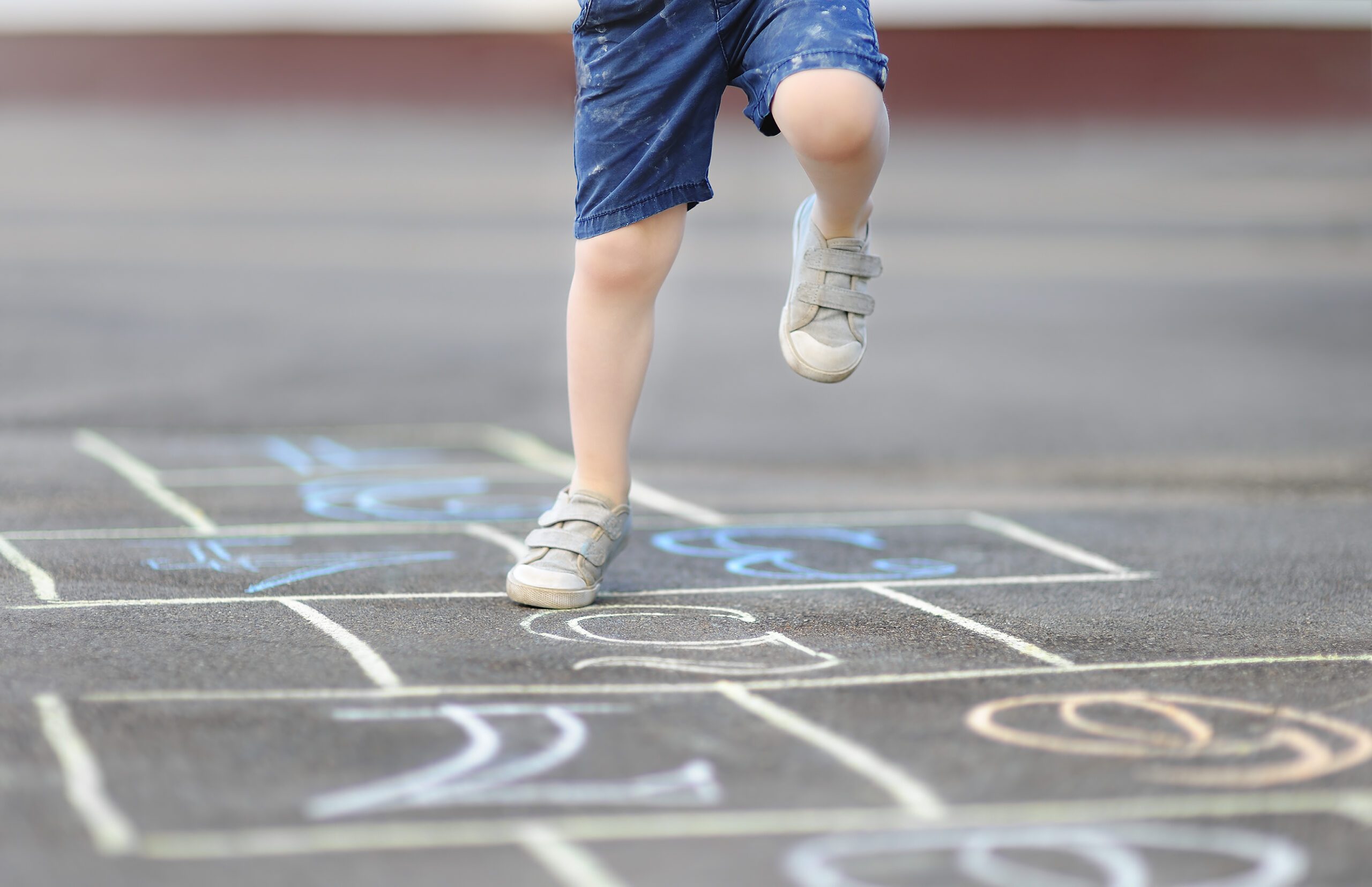 Closeup-of-little-boys-leg-playing-hopscotch-scaled