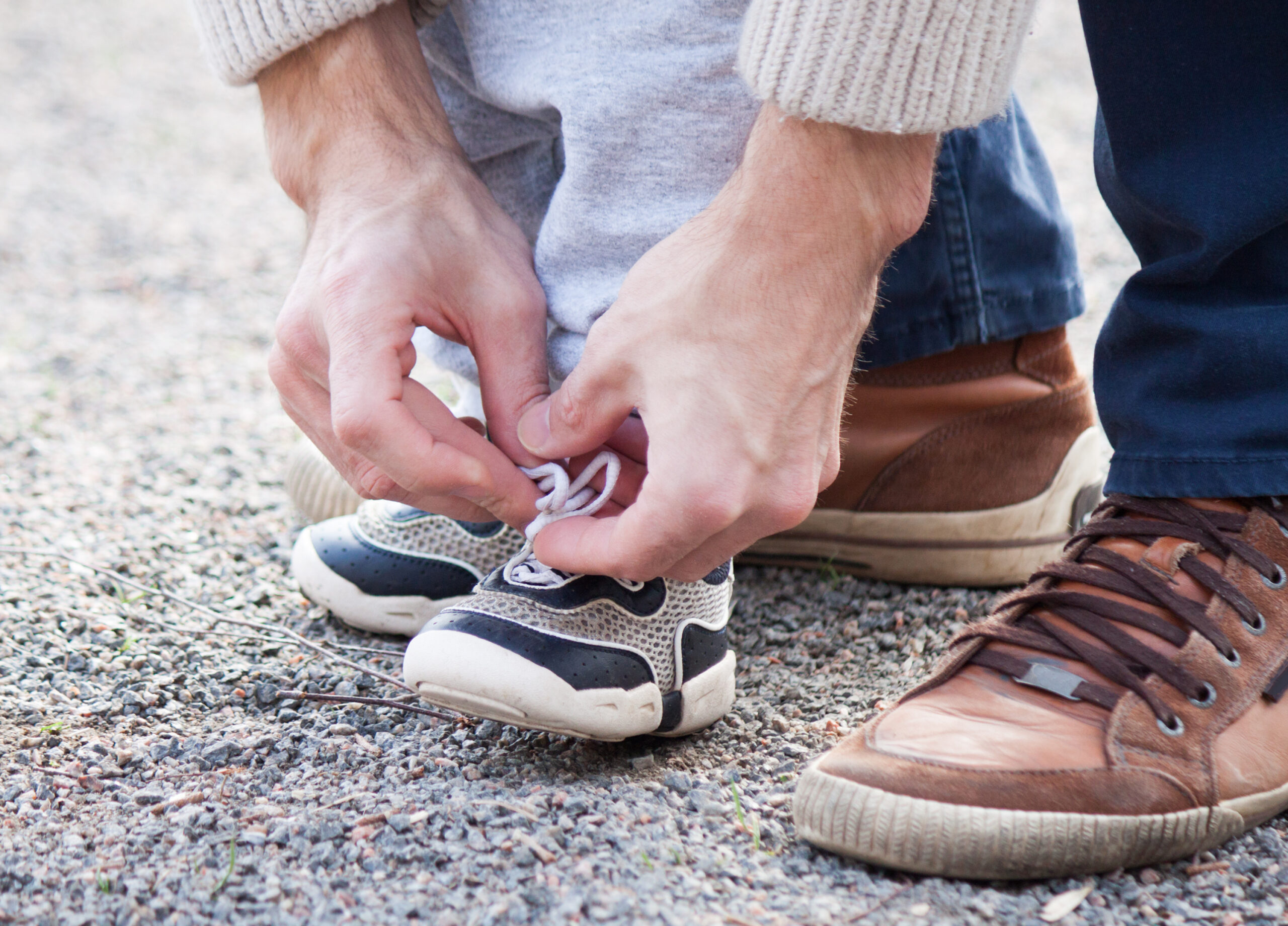 Dad-tying-childs-shoe-lace--scaled