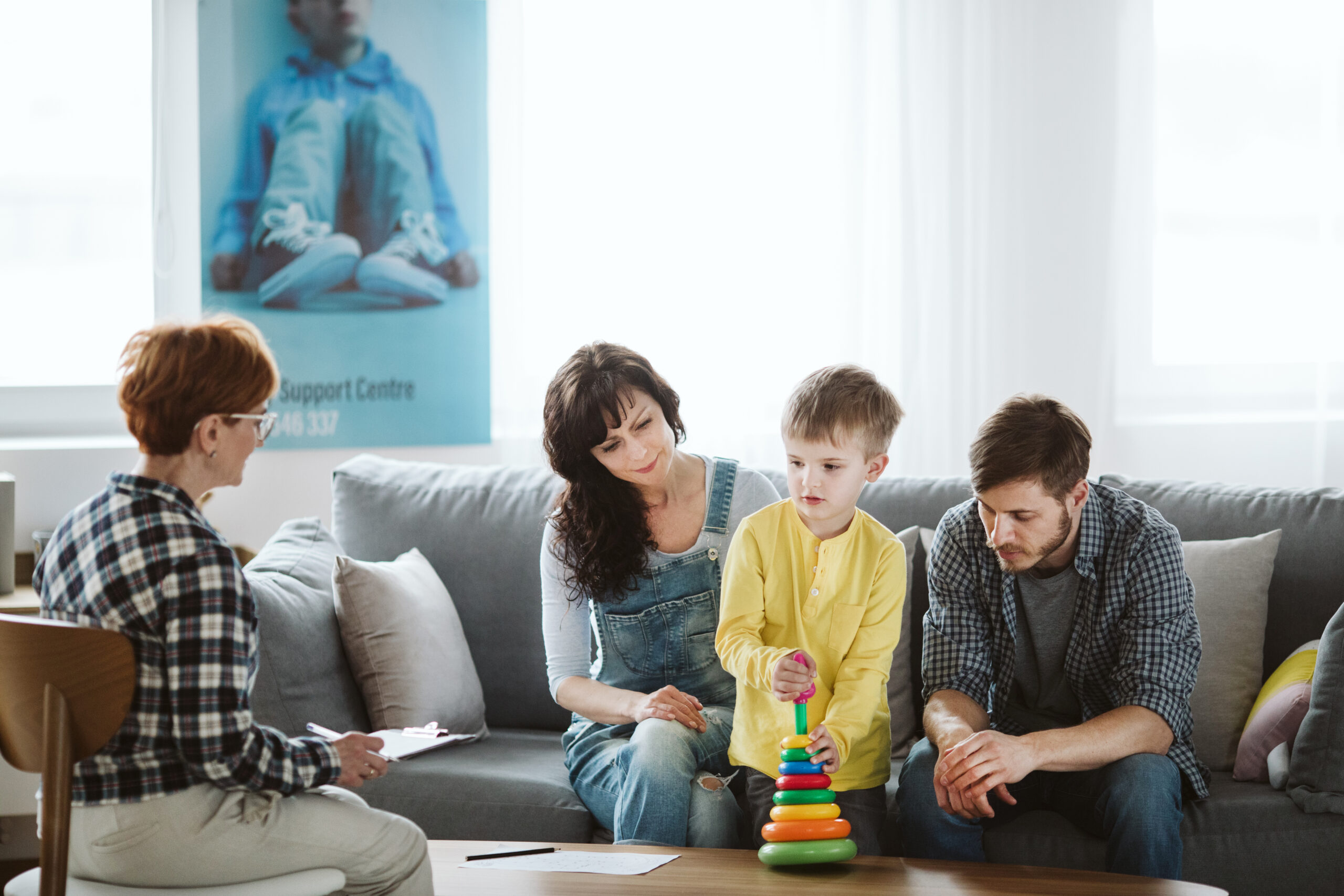 Therapy-meeting-with-parents-and-young-boy-scaled