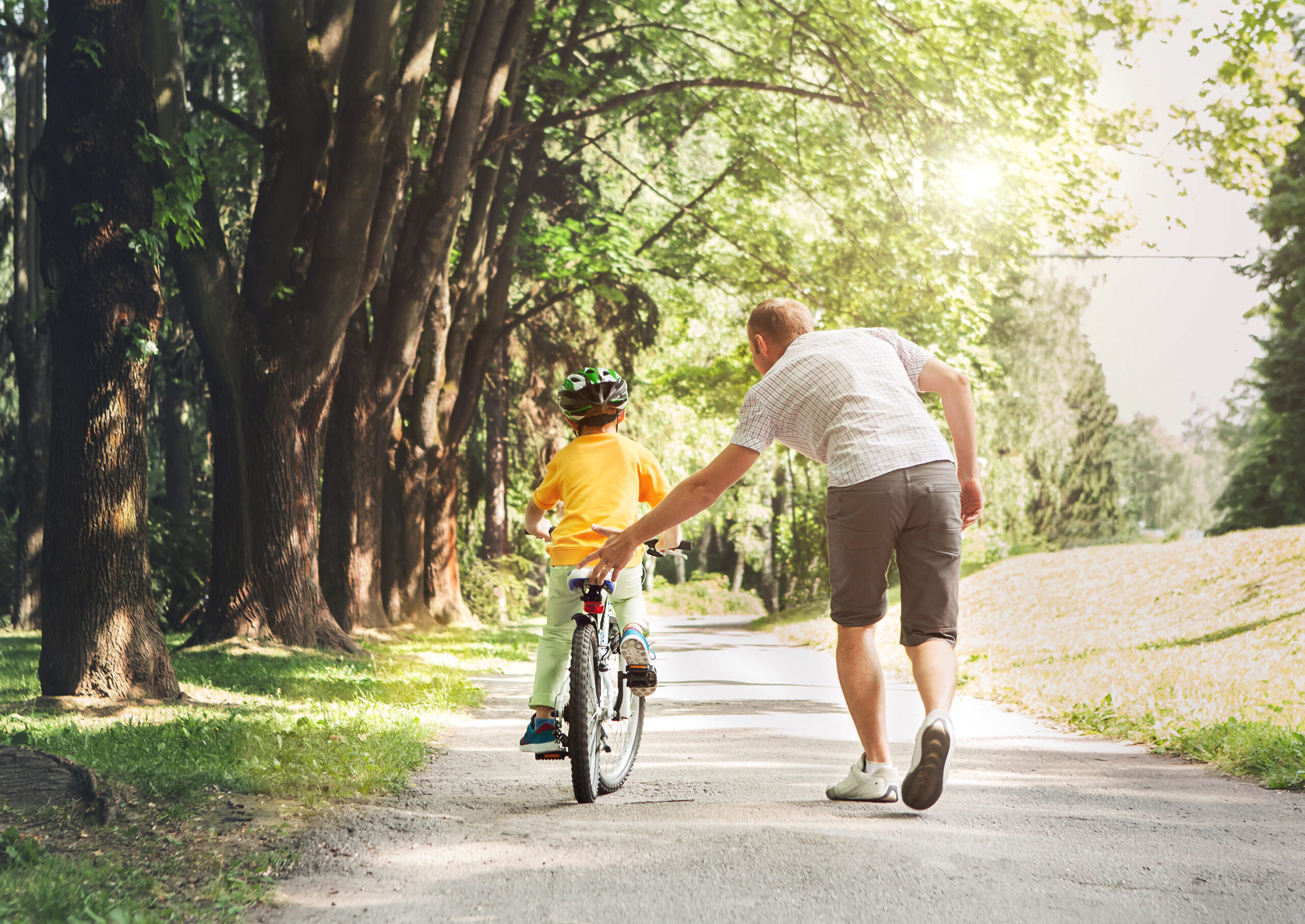 Father-helping-son-ride-a-bicycle-scaled-1